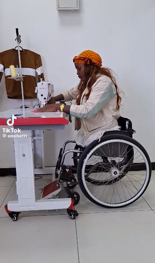 Woman in wheelchair using adaptive sewing machine
